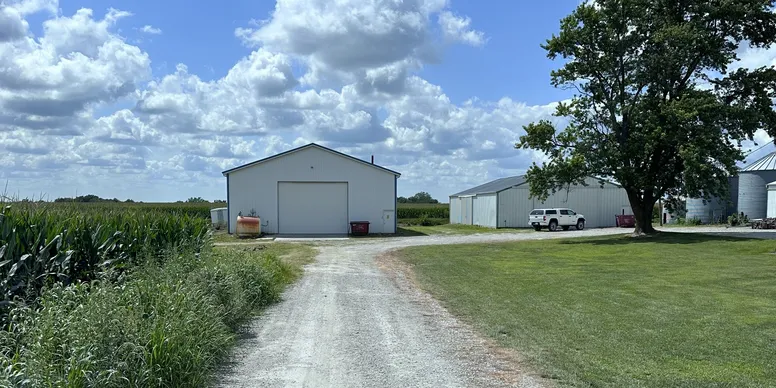 Rural farm buildings under cloudy sky